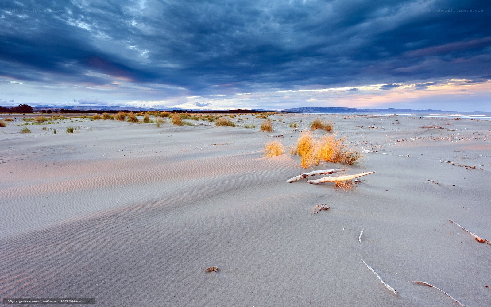 Dunes at sunset with stormy sky