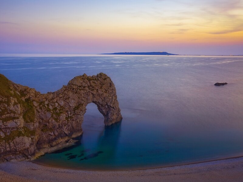 Durdle Door Rock Arch — Blue, Serene, Sunset, Photograph, Sea, Sky, Beach