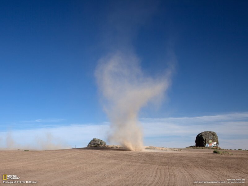 Dust devil over desert rocks
