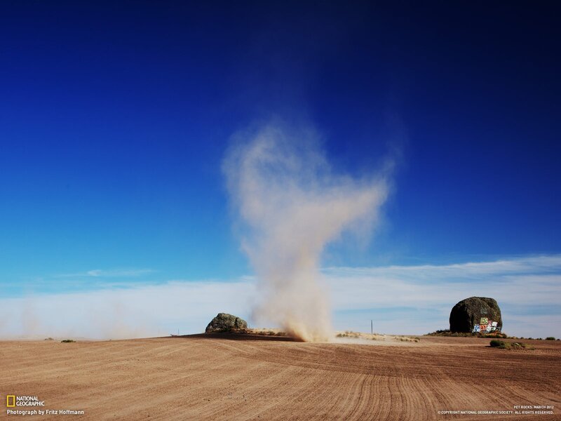 Dust devil over desert rocks