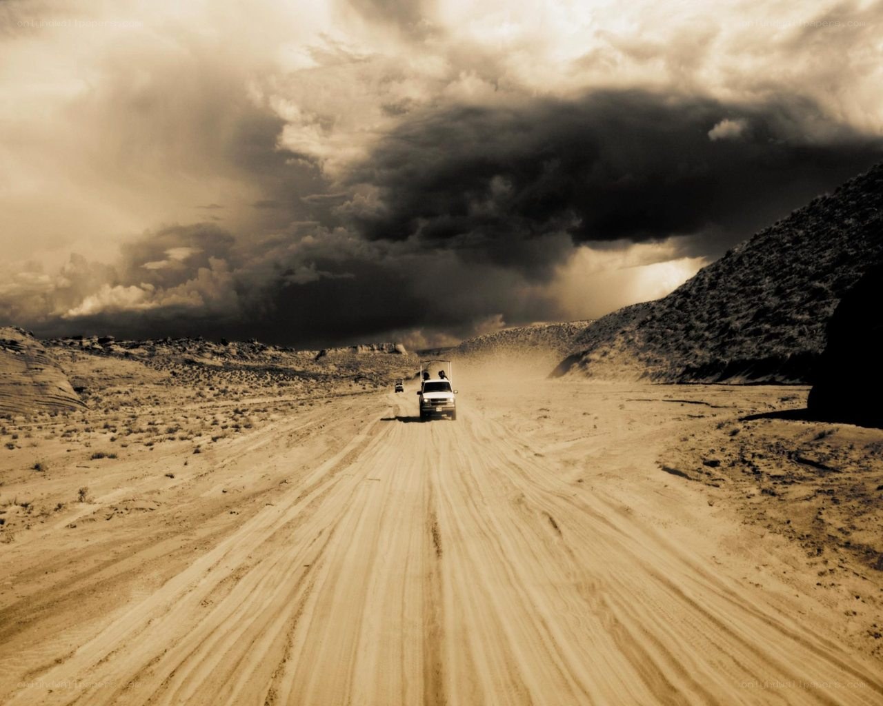 Dusty road under stormy sky