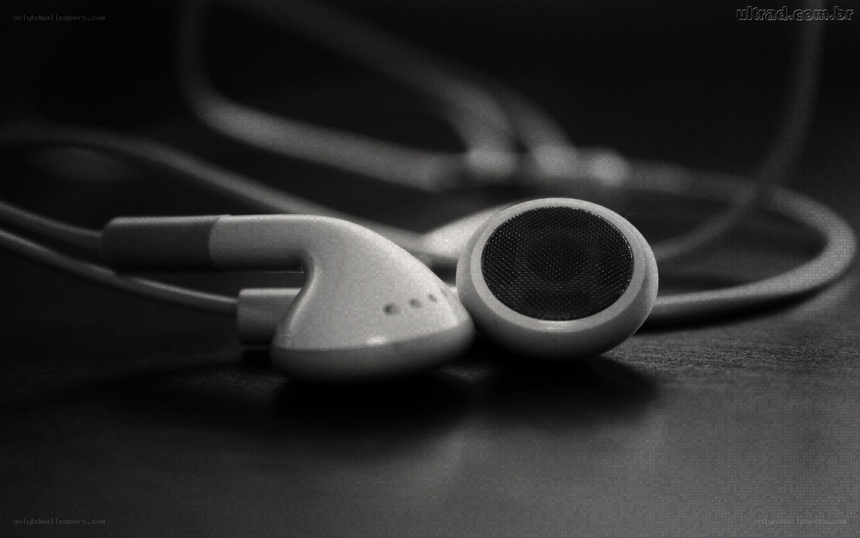 earbuds on dark surface
