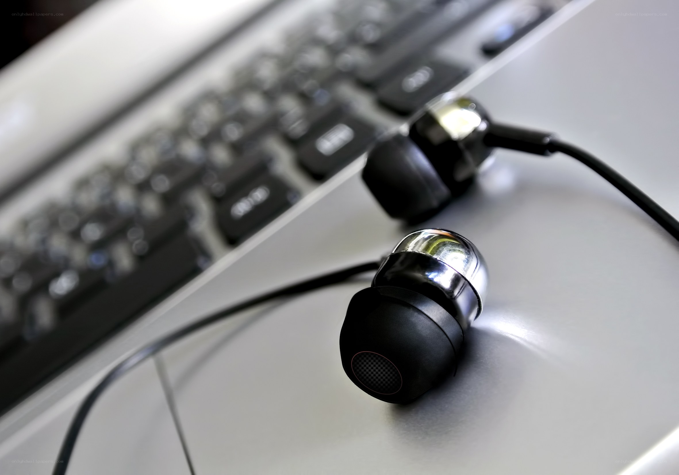 earbuds on laptop surface