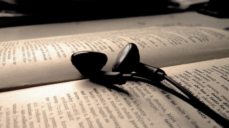 earbuds on open book