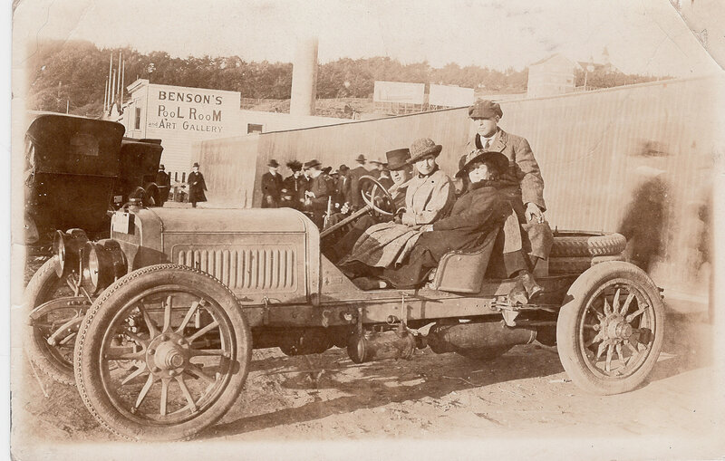 Early 1900s car with passengers