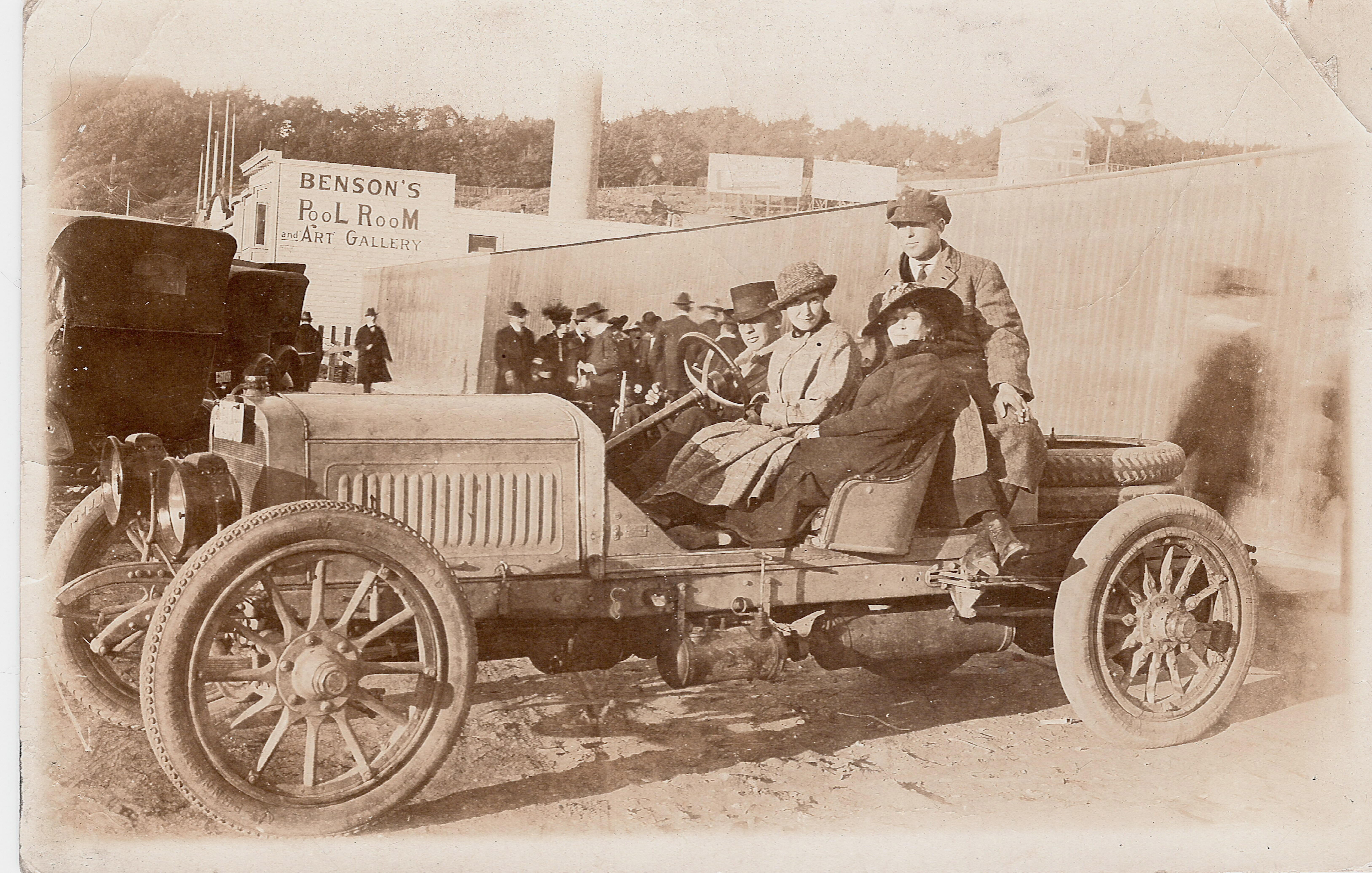 Early 1900s car with passengers