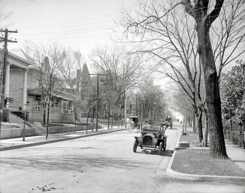 Early automobile on a residential street