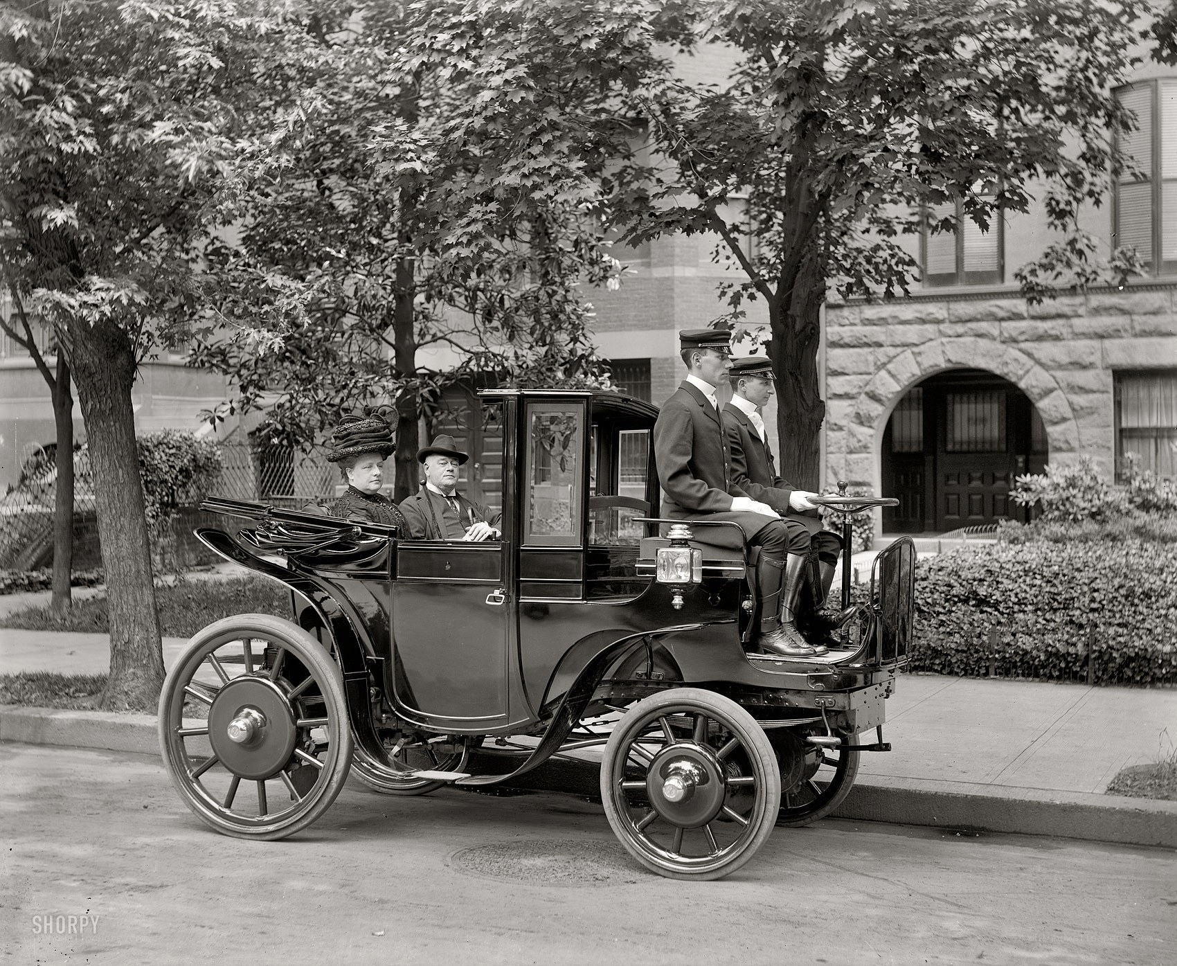 Early automobile with passengers