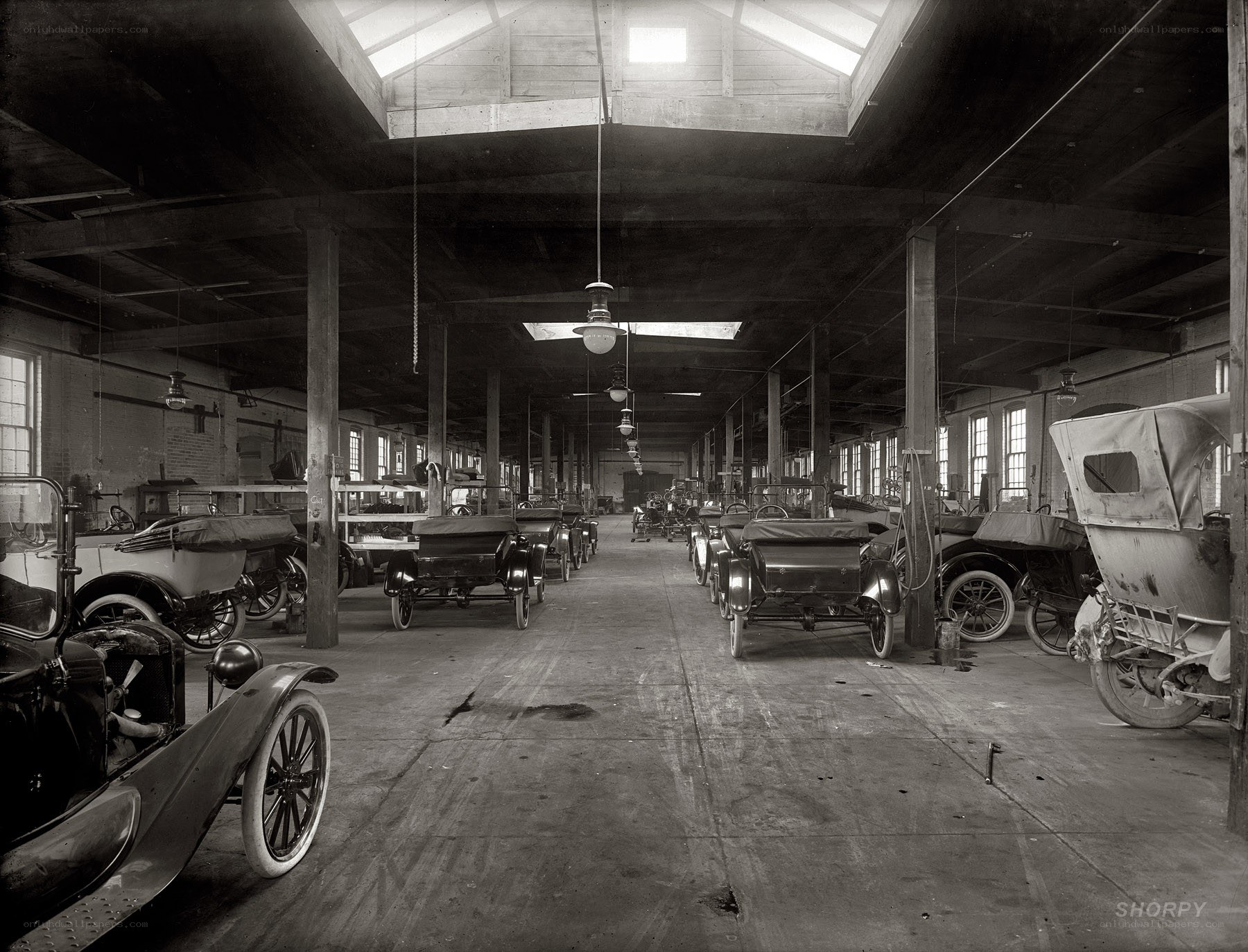 Early automobiles in a factory