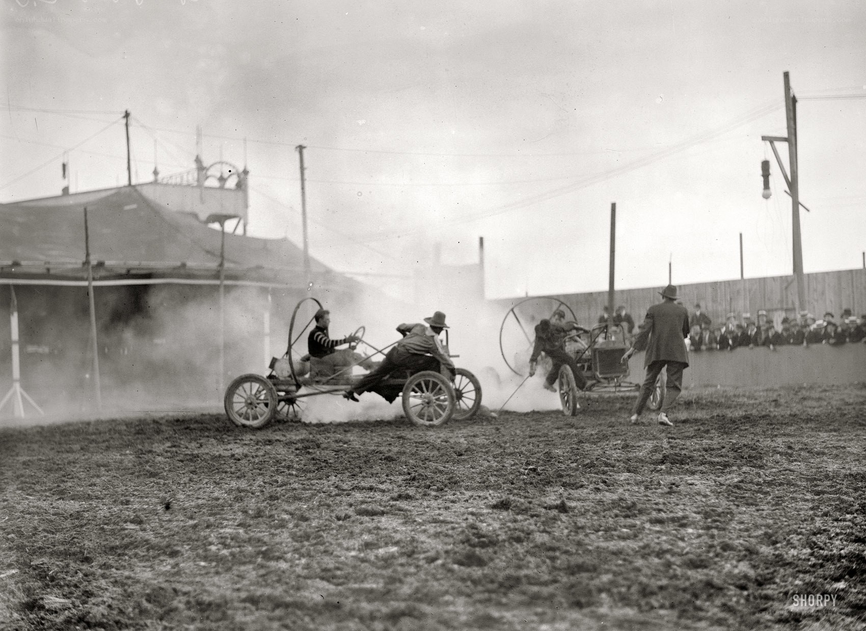 Early car race on dirt track