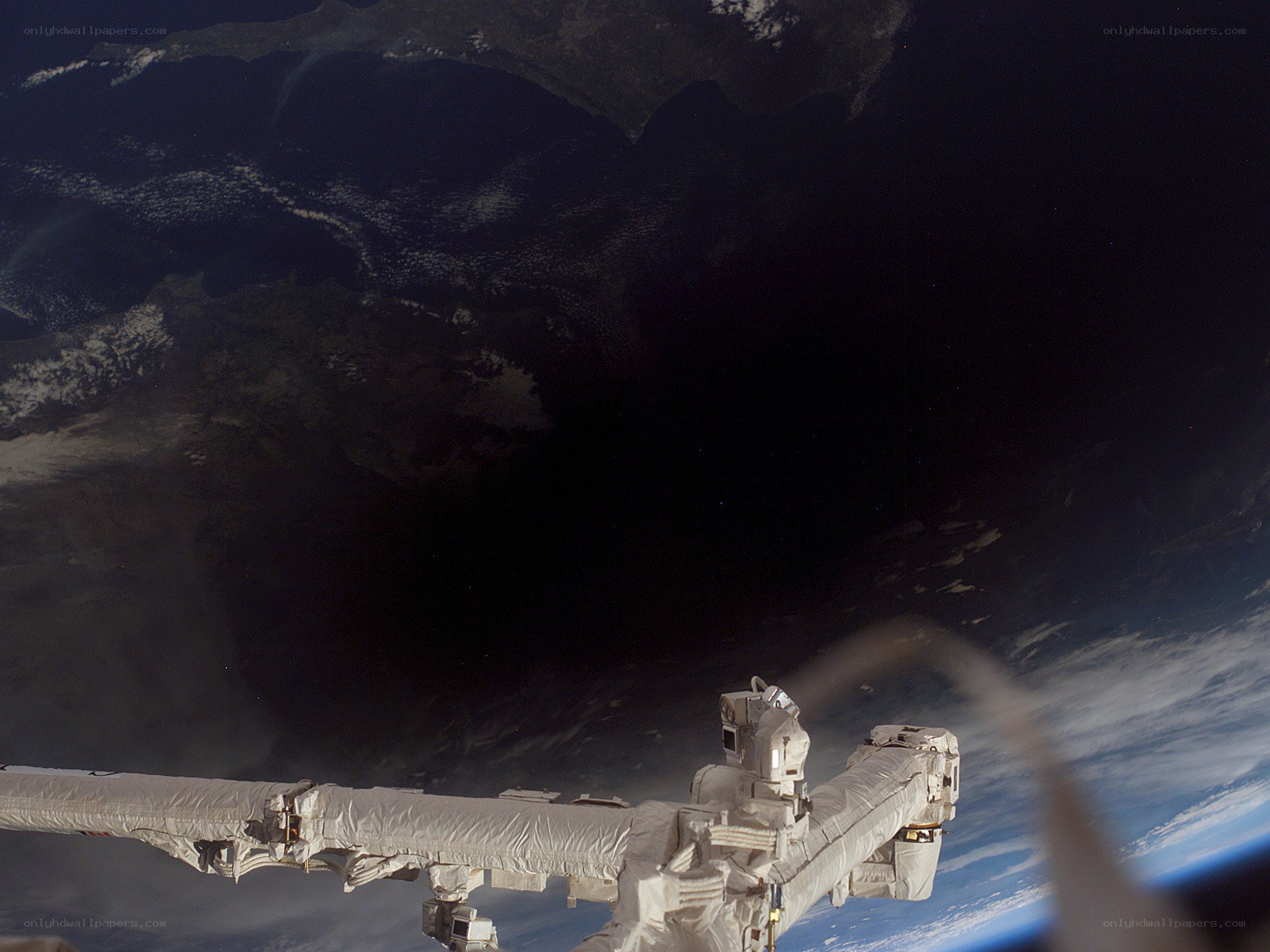 Earth from space with ISS arm