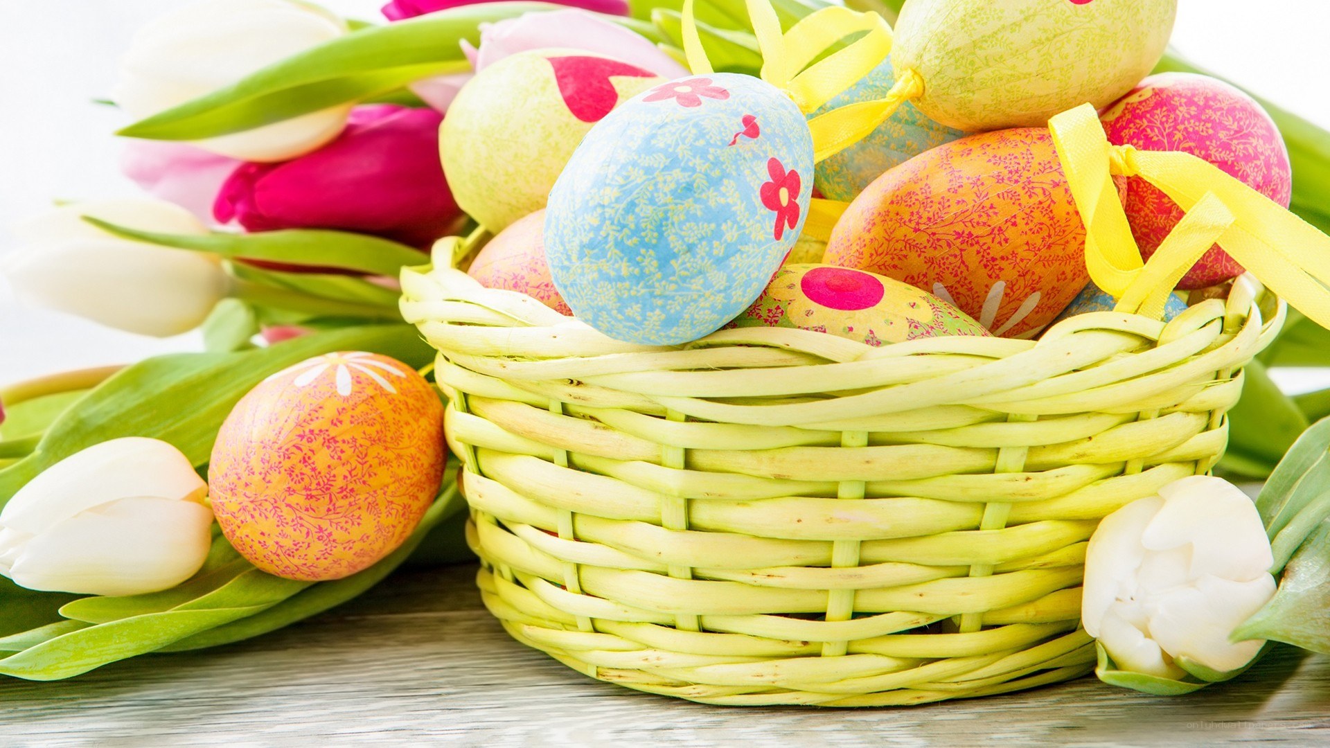 Easter basket with eggs and tulips