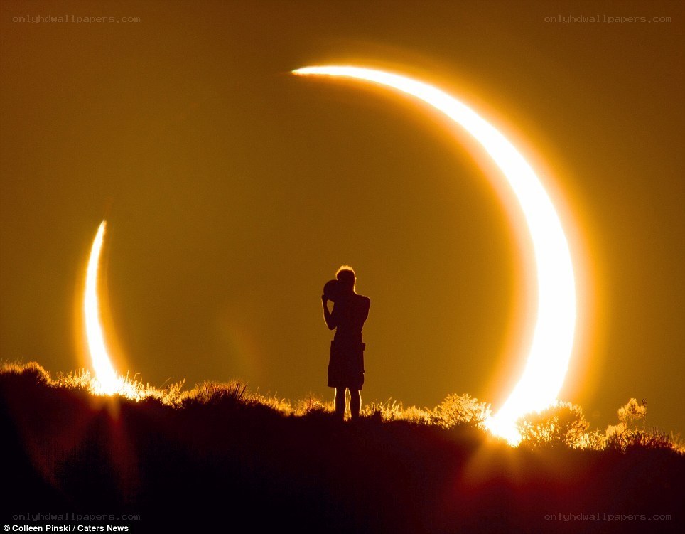 Eclipse silhouette on hill