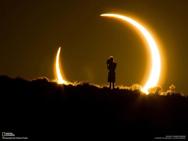 Eclipse silhouette on hilltop