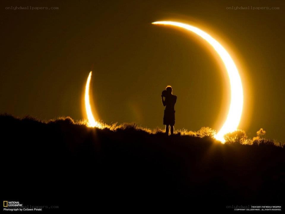Eclipse silhouette on hilltop
