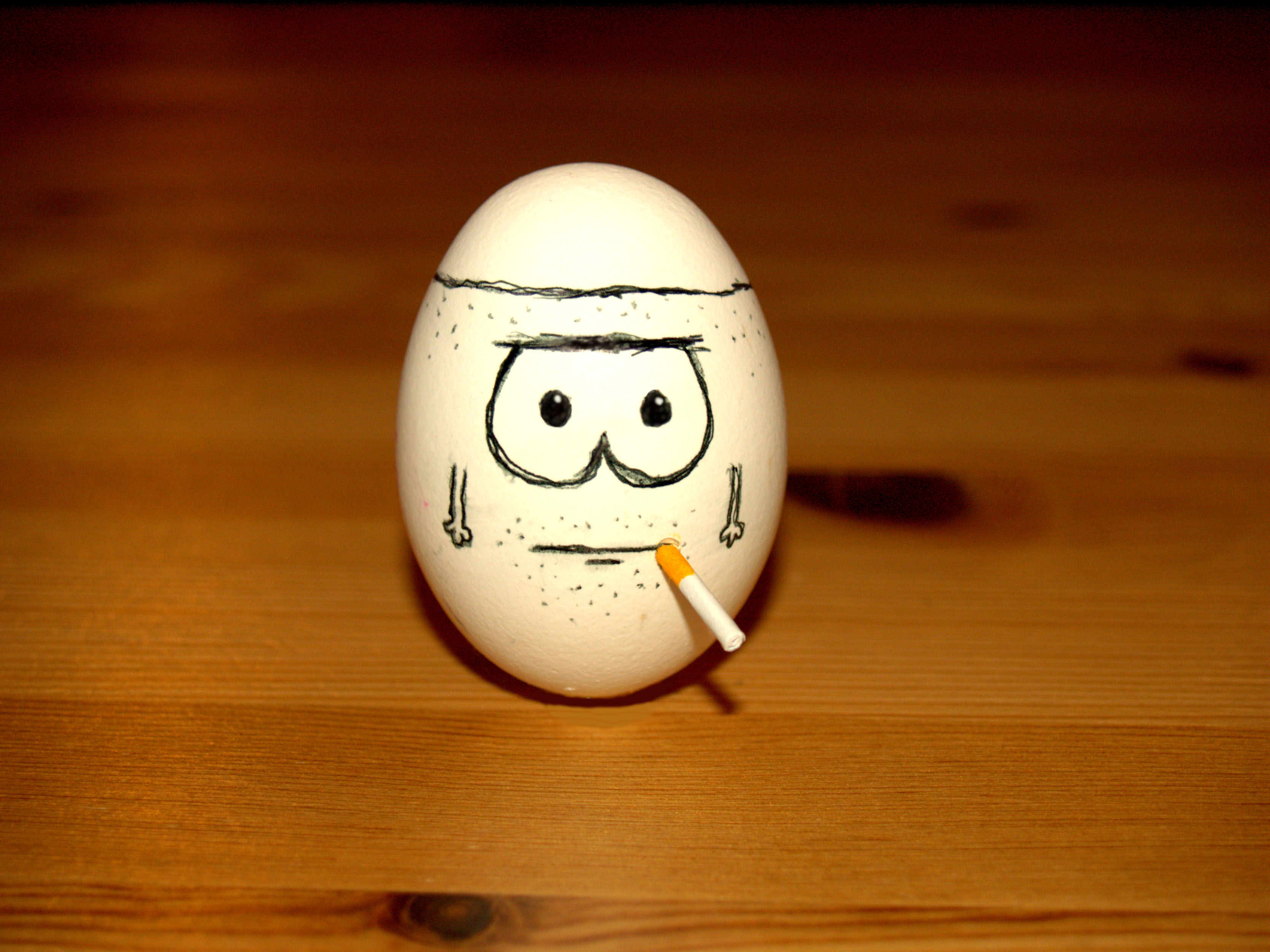egg with drawn face and cigarette