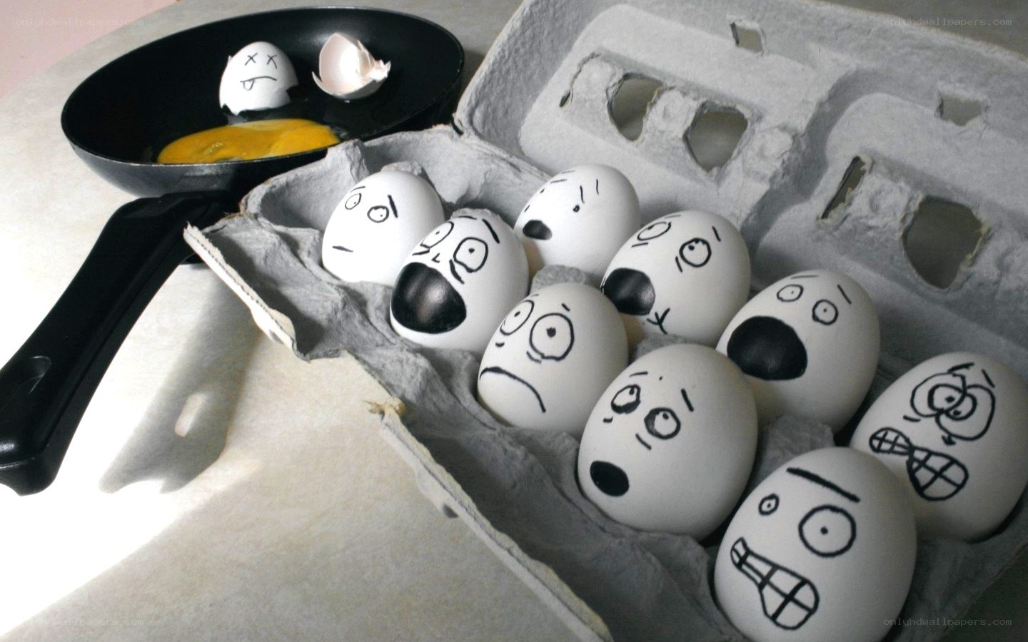 Eggs with drawn faces in carton