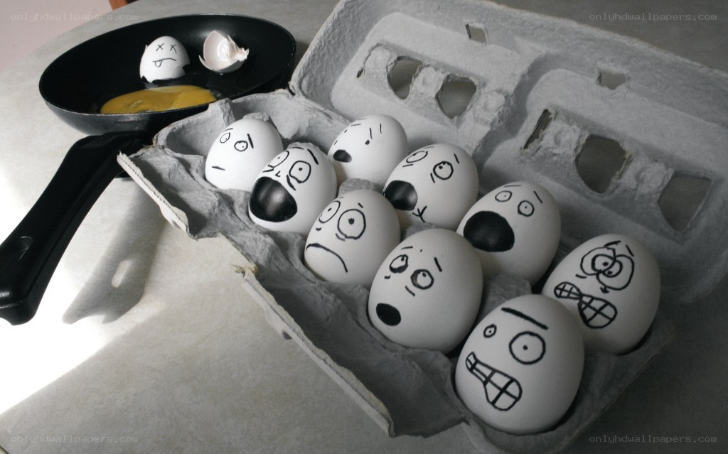 Eggs with drawn faces in carton