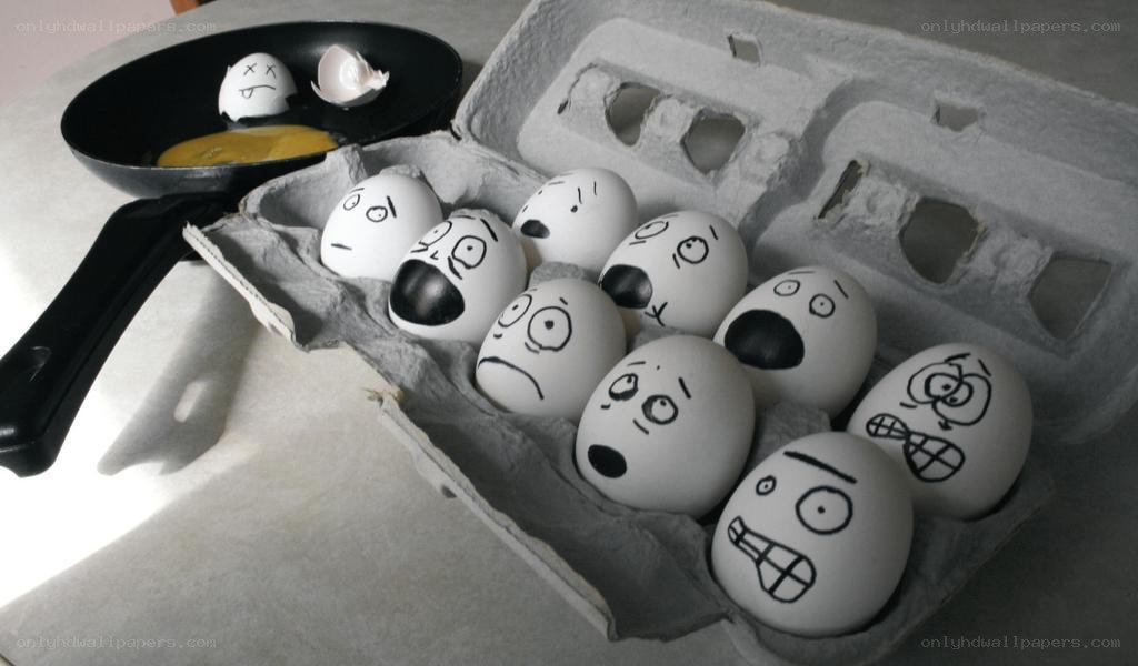 Eggs with drawn faces in carton