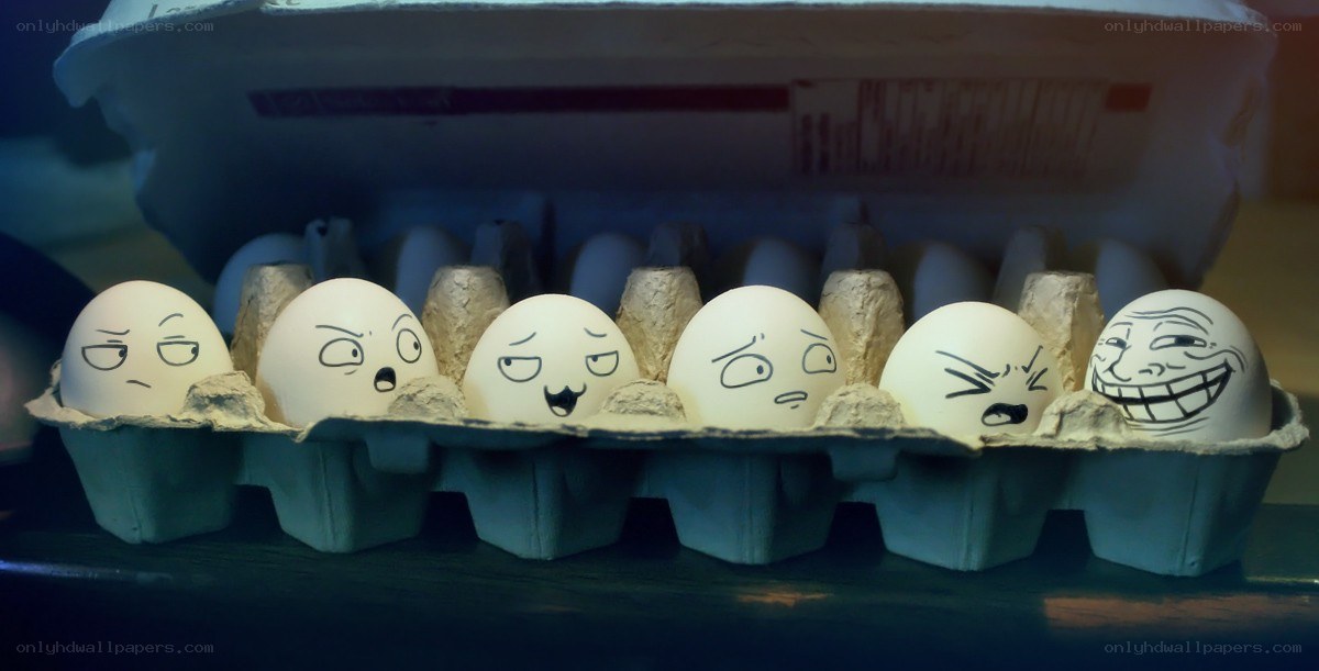 Eggs with drawn faces in carton