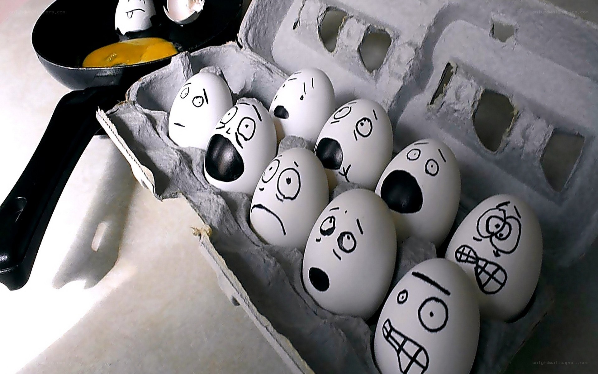 Eggs with drawn faces in carton
