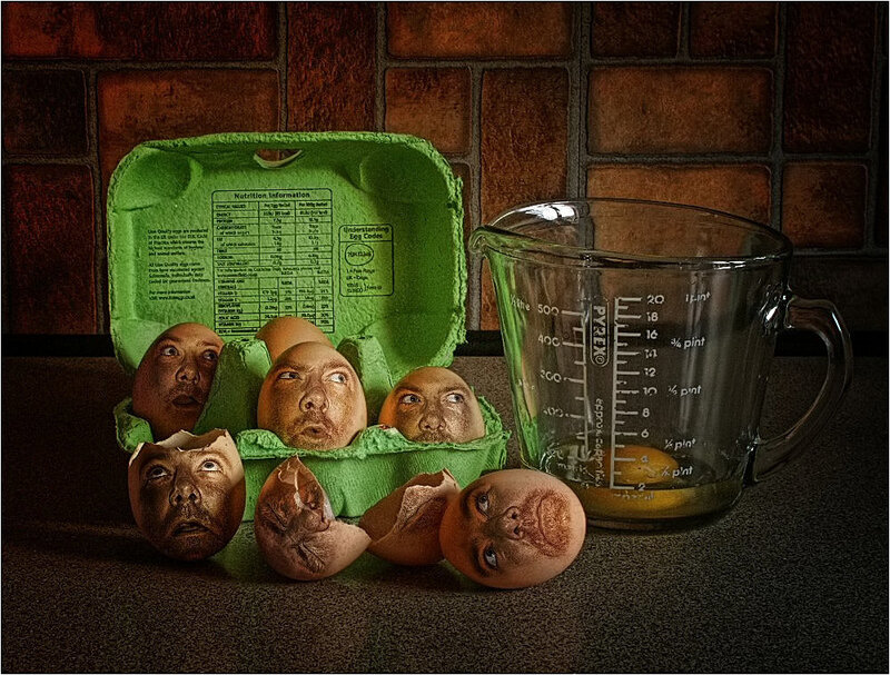 Eggs with faces in carton