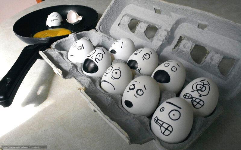 Eggs with faces in carton