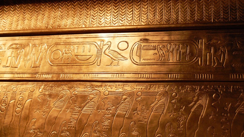 Egyptian hieroglyphs on golden surface