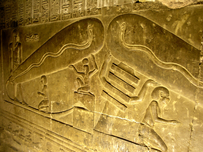 Egyptian wall carving with serpents