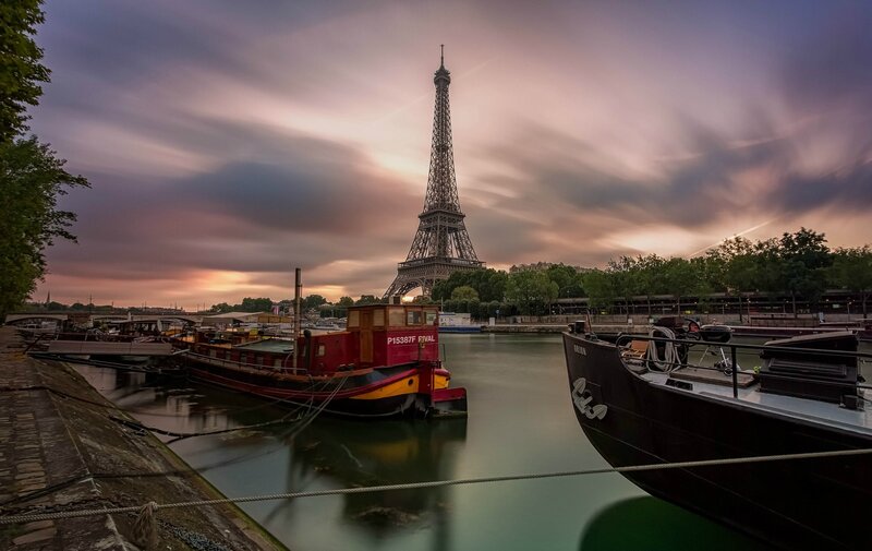 Eiffel Tower at dusk with boats