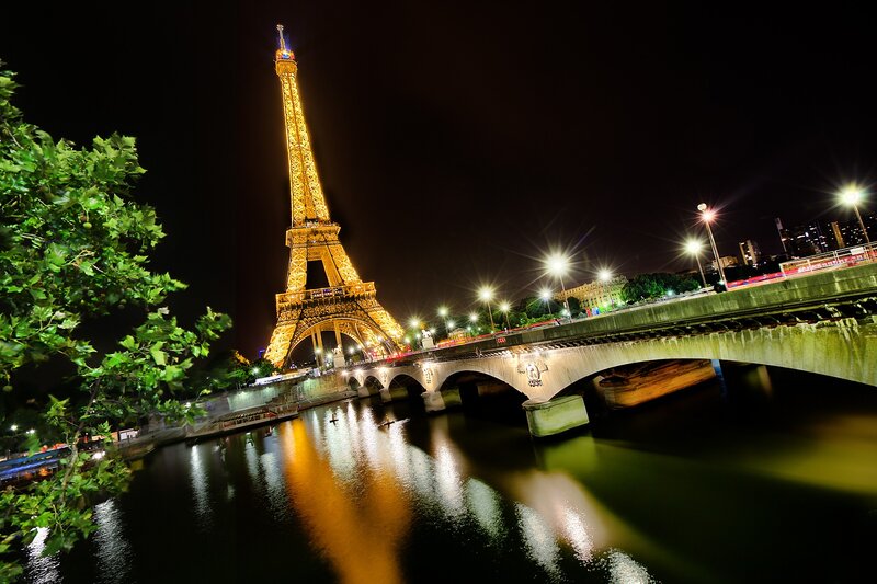 Eiffel Tower at Night — Black, Dramatic, Photograph, Bridge, River, Trees, Yellow