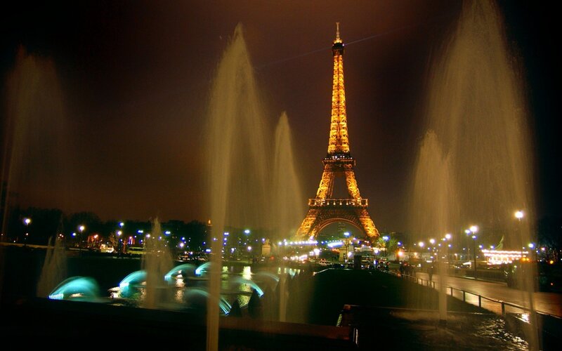 Eiffel Tower at night with fountains