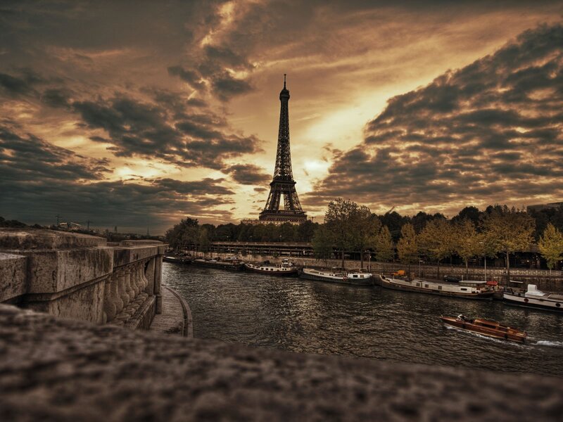 Eiffel Tower at Sunset — Brown, Dramatic, Photograph, River, Boats, Trees, Orange