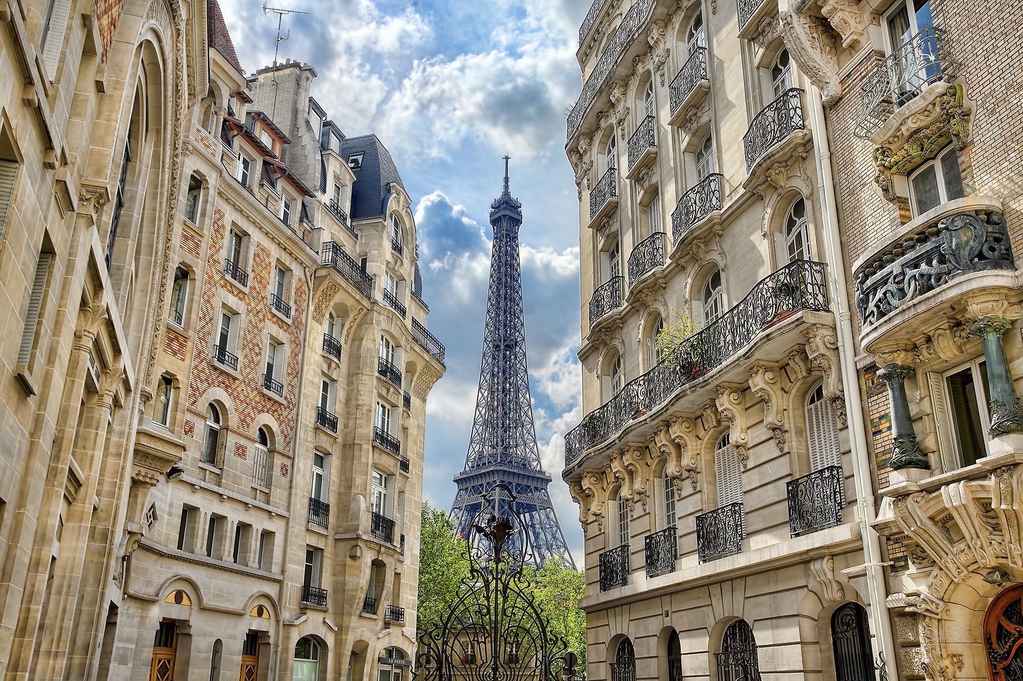 Eiffel Tower between Parisian buildings