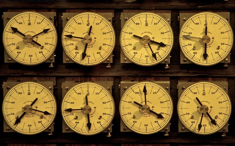 eight vintage clocks on a wall