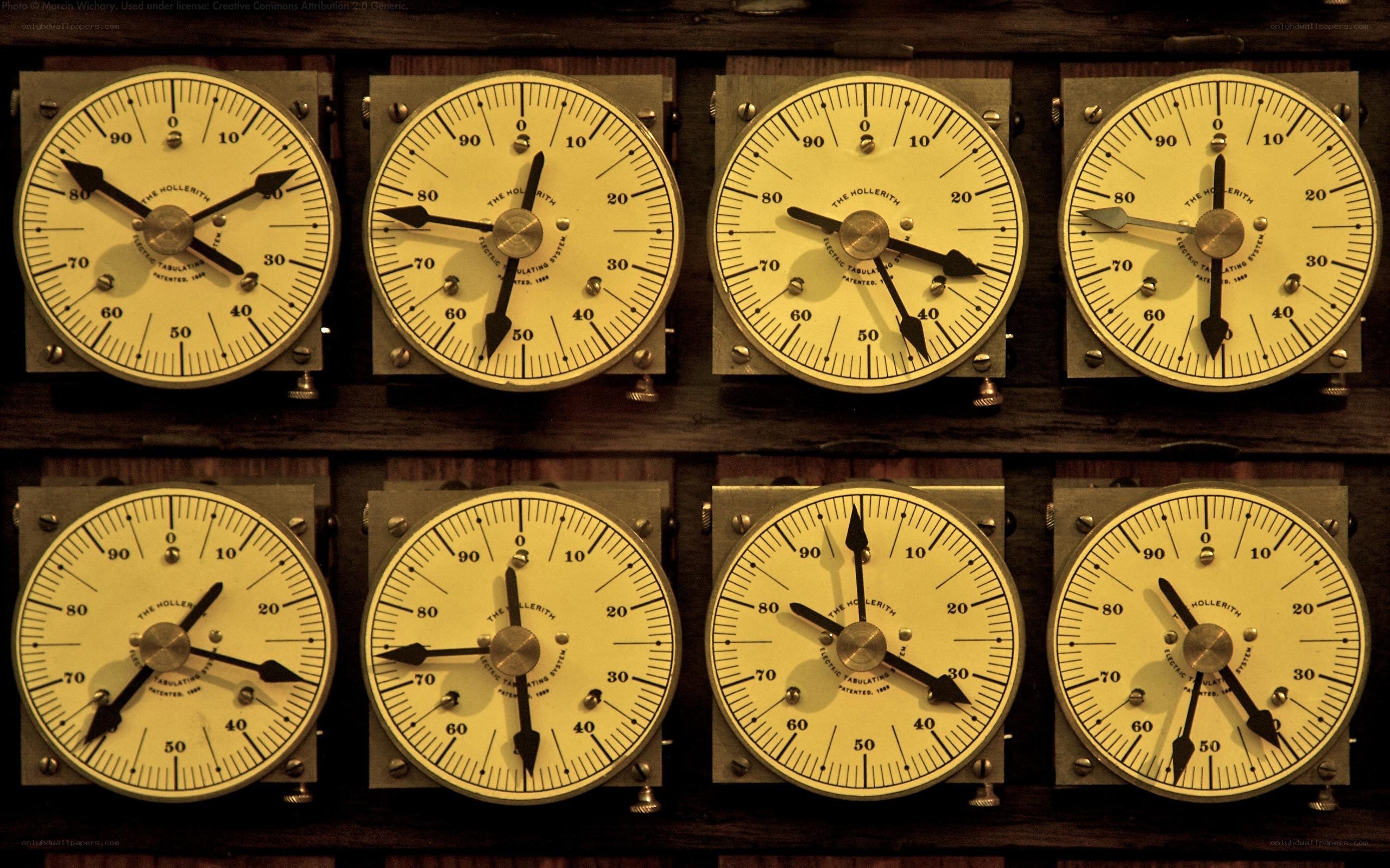 eight vintage clocks on a wall
