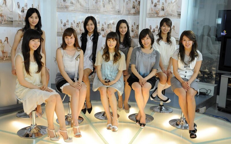 Eight Women Sitting on Stools