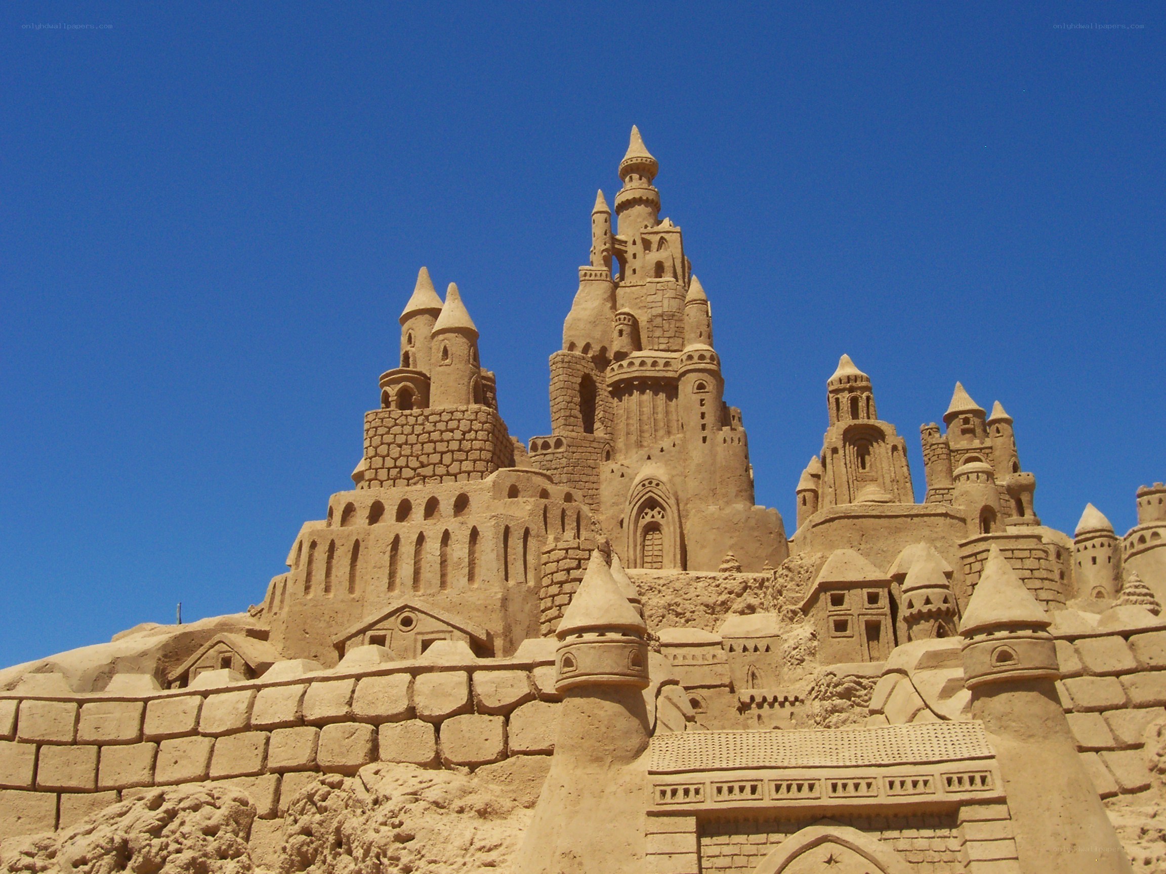 elaborate sandcastle under blue sky