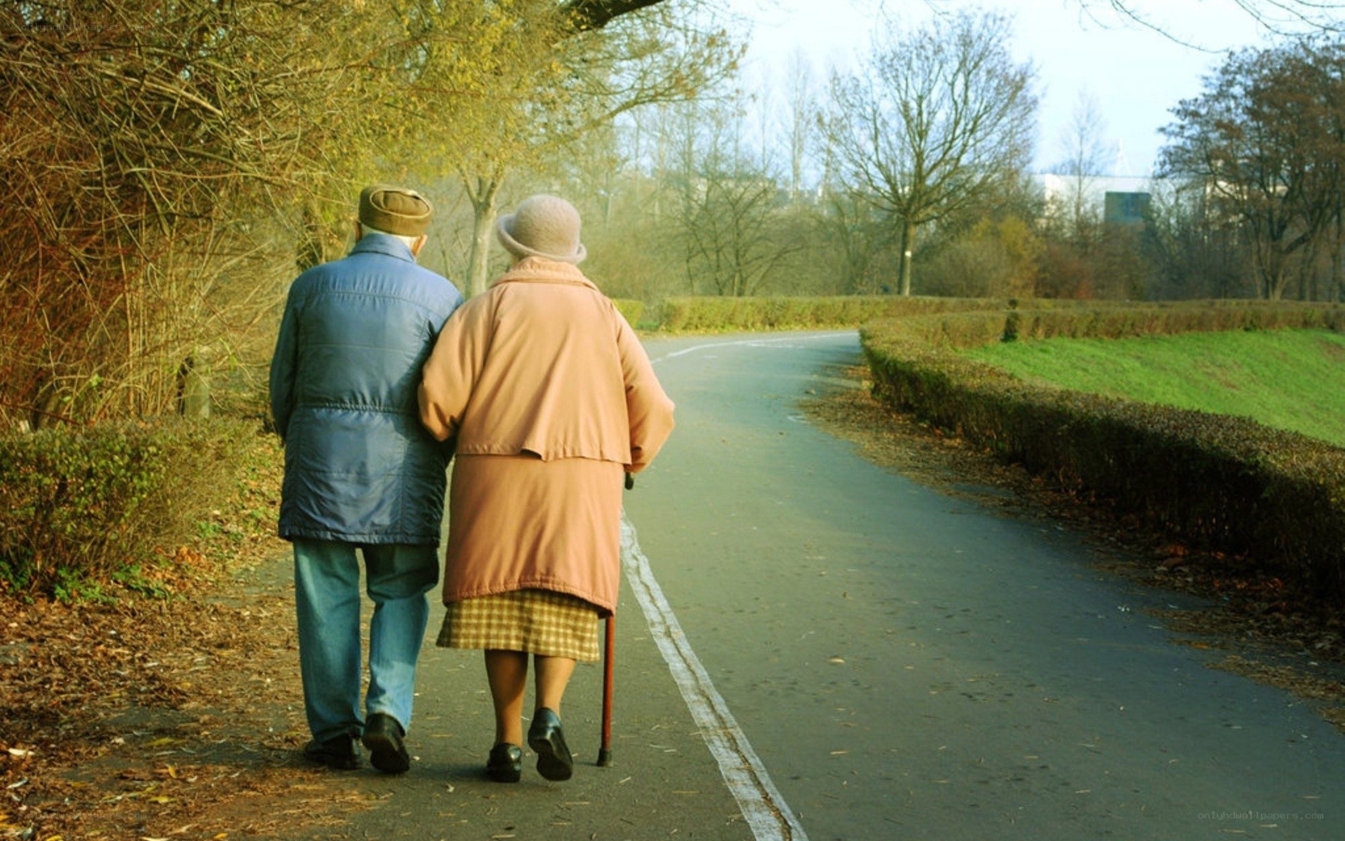 elderly couple walking in park