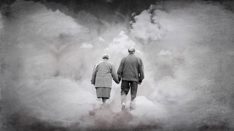 elderly couple walking together