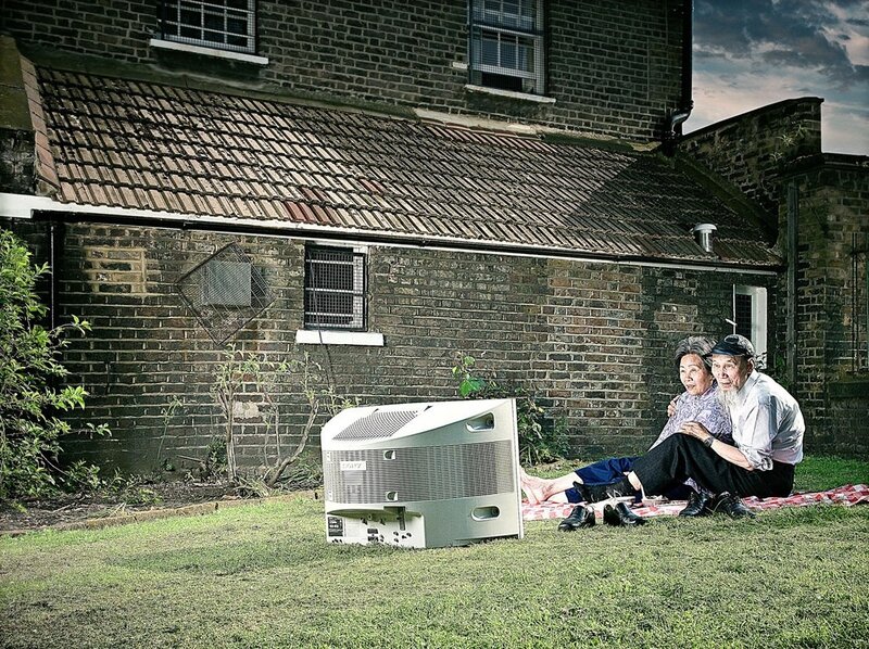 Elderly couple watching TV outdoors