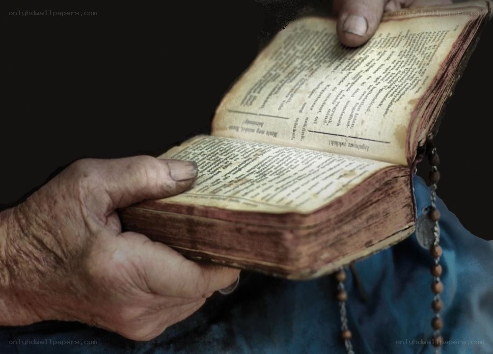elderly hands holding a book