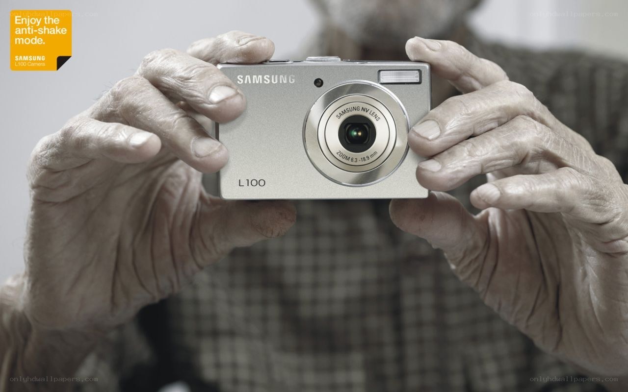 Elderly hands holding Samsung camera