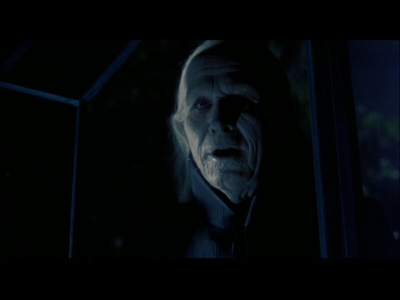 Elderly Man in Dark Room