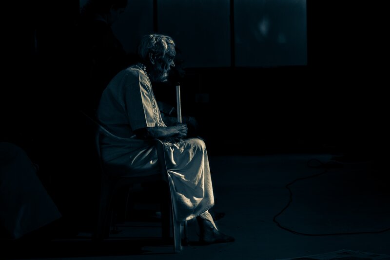 elderly man in dim light