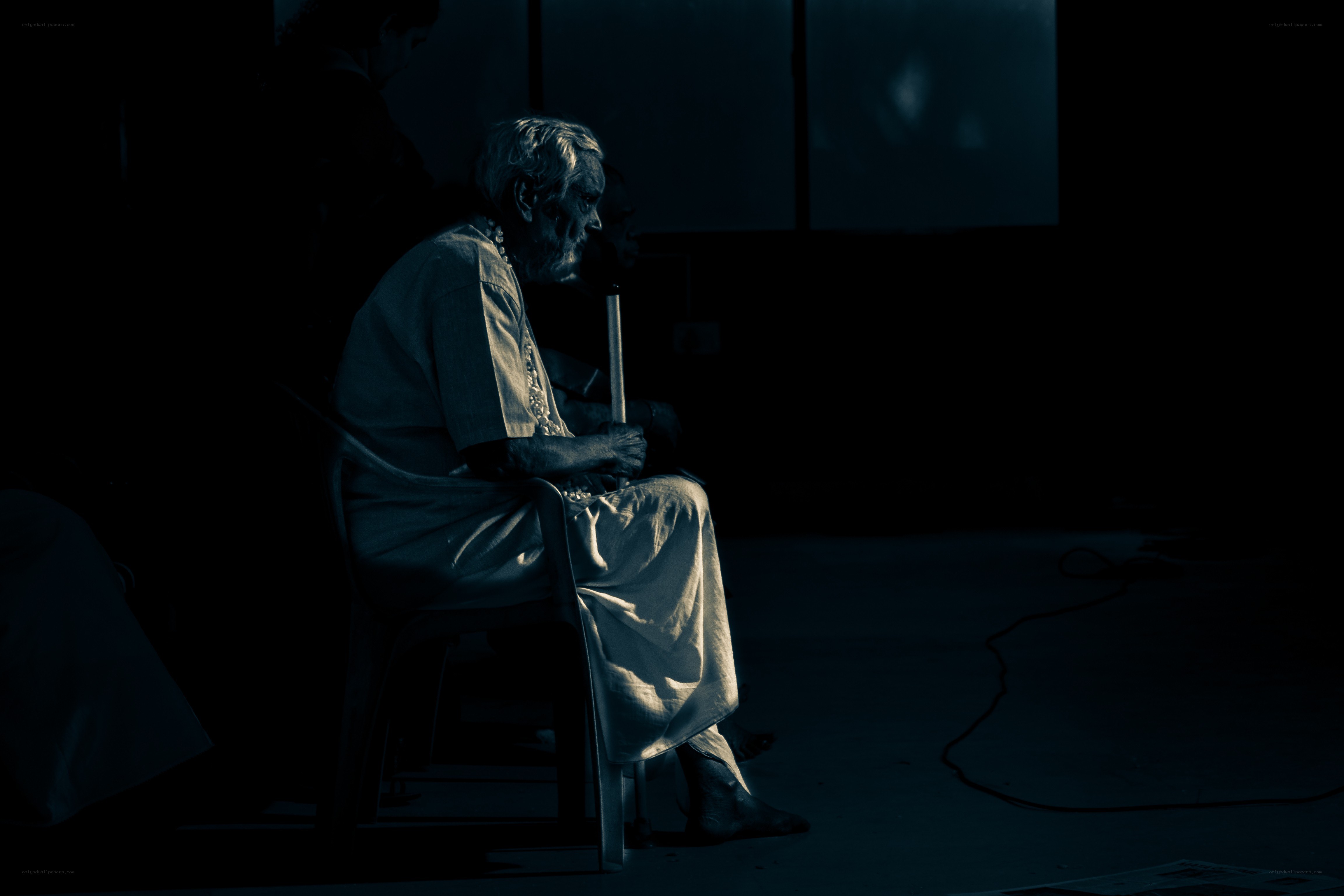 elderly man in dim light