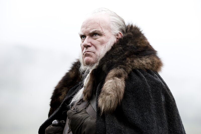 elderly man in fur cloak