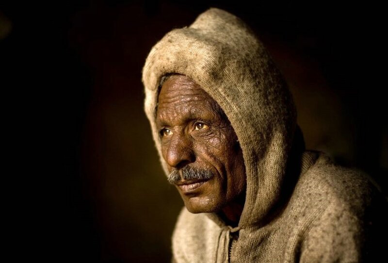 elderly man in hooded garment
