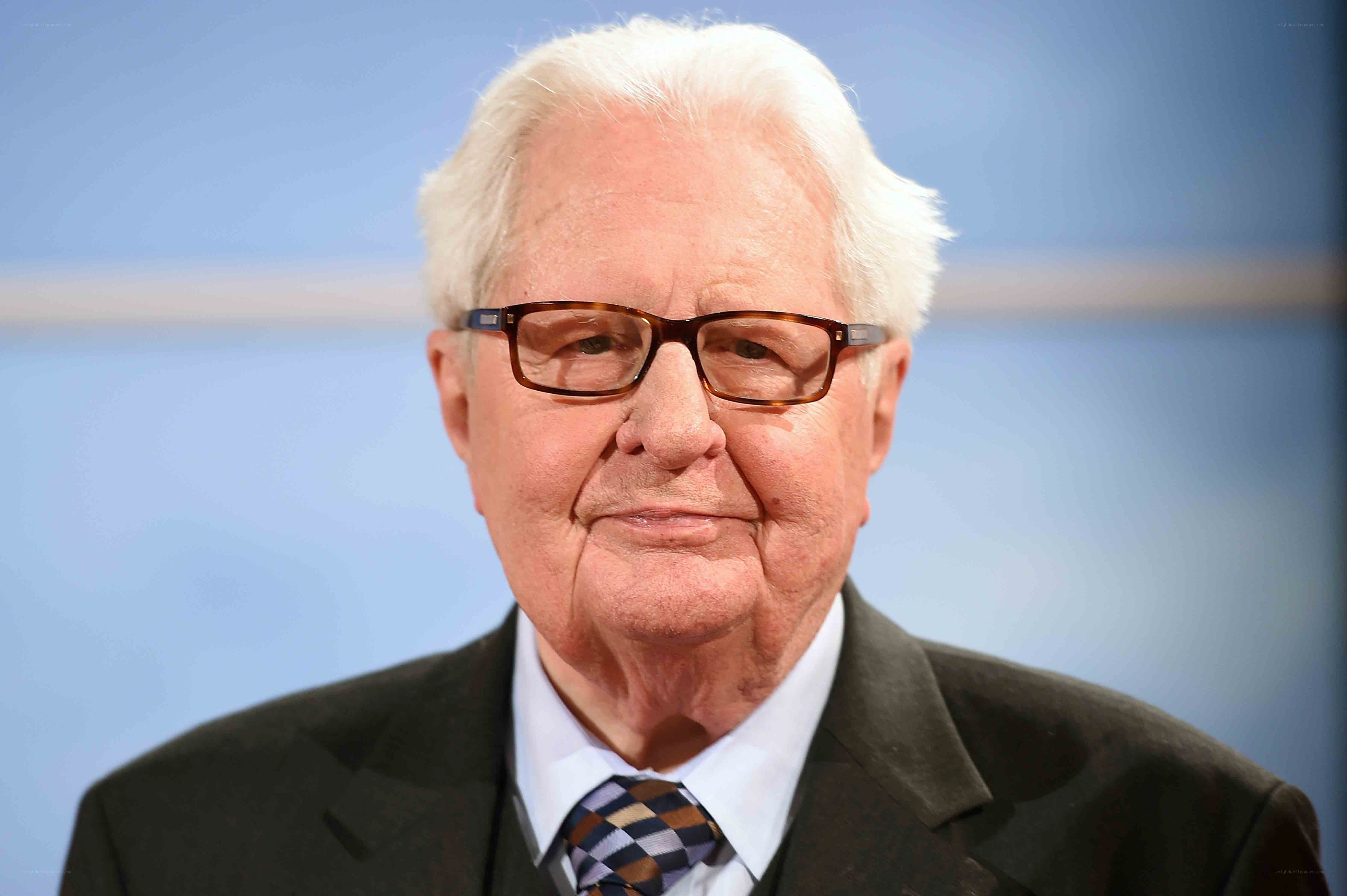 elderly man in suit and glasses
