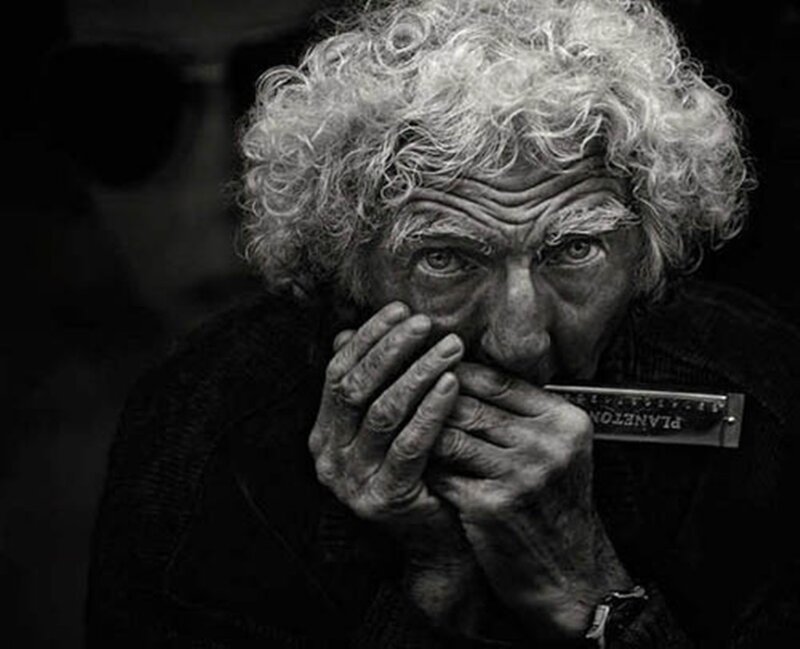Elderly Man Playing Harmonica